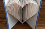 Book pages folded into the shape of a heart.